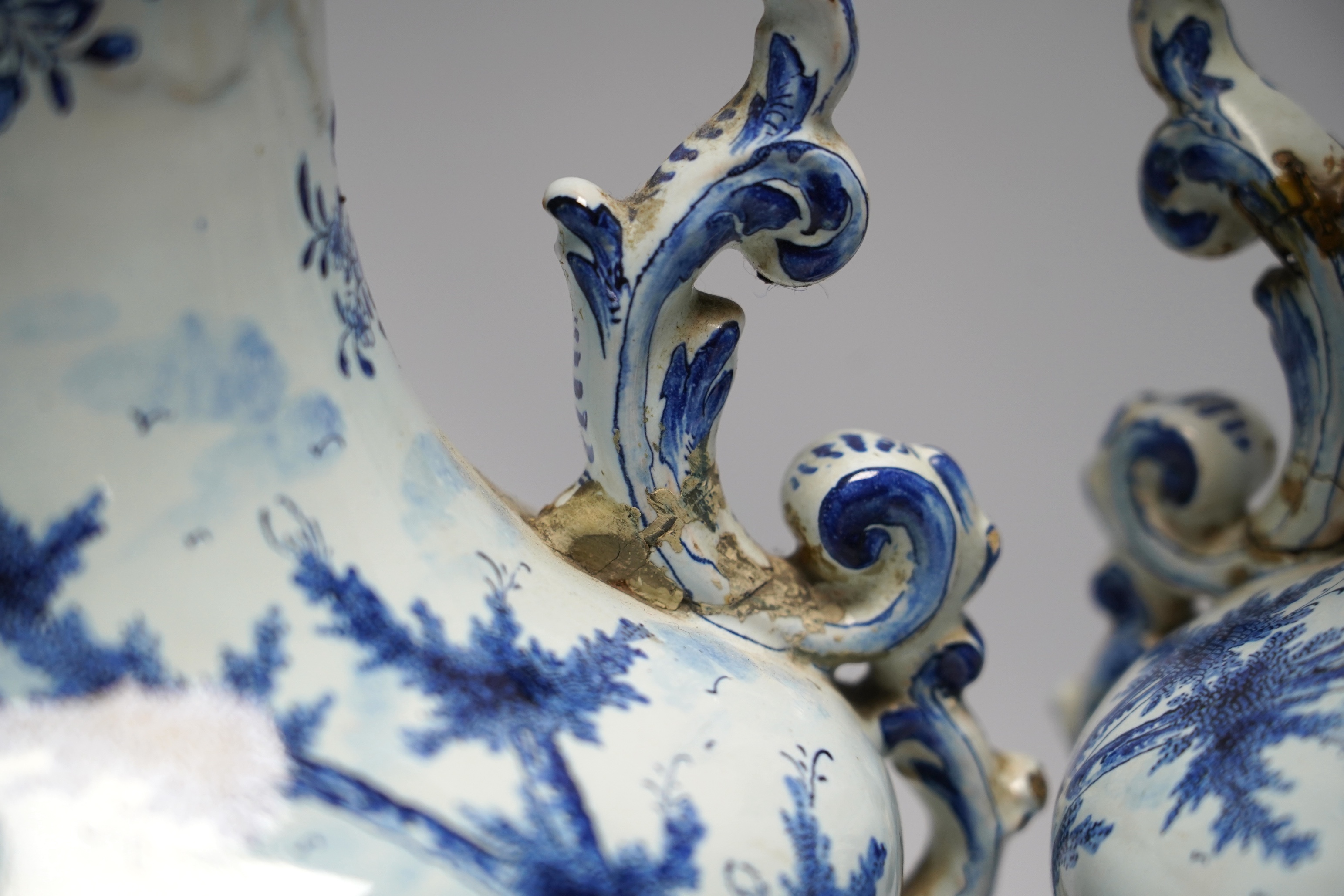 A pair of 19th century Delft blue and white vases, 35cm high. Condition - poor